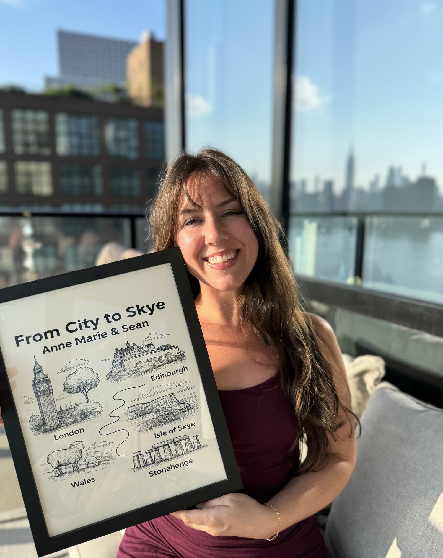 A smiling woman holding a framed StoryMap titled From City to Skye.